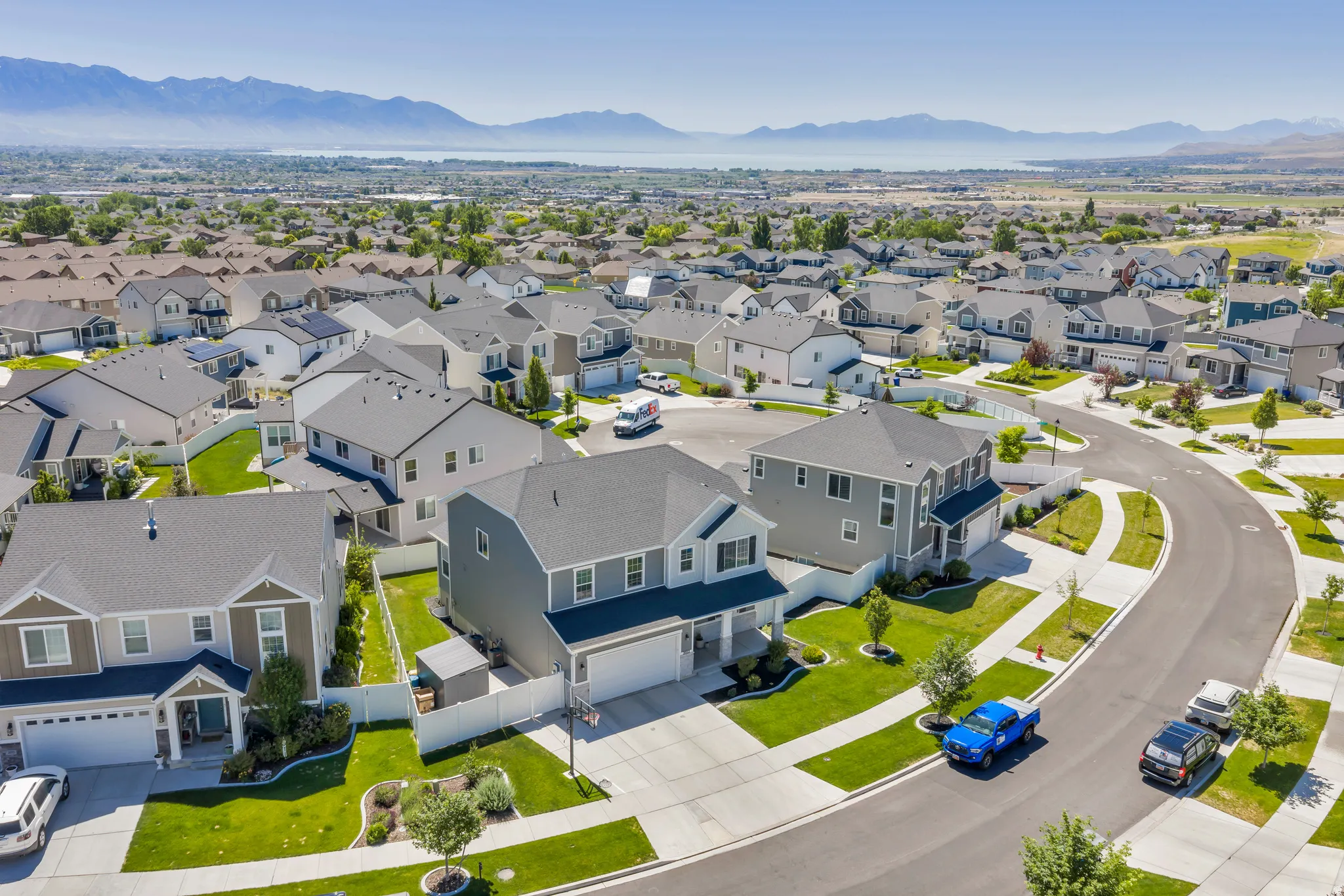 Expansive residential development featuring contemporary homes with manicured lawns and paved streets