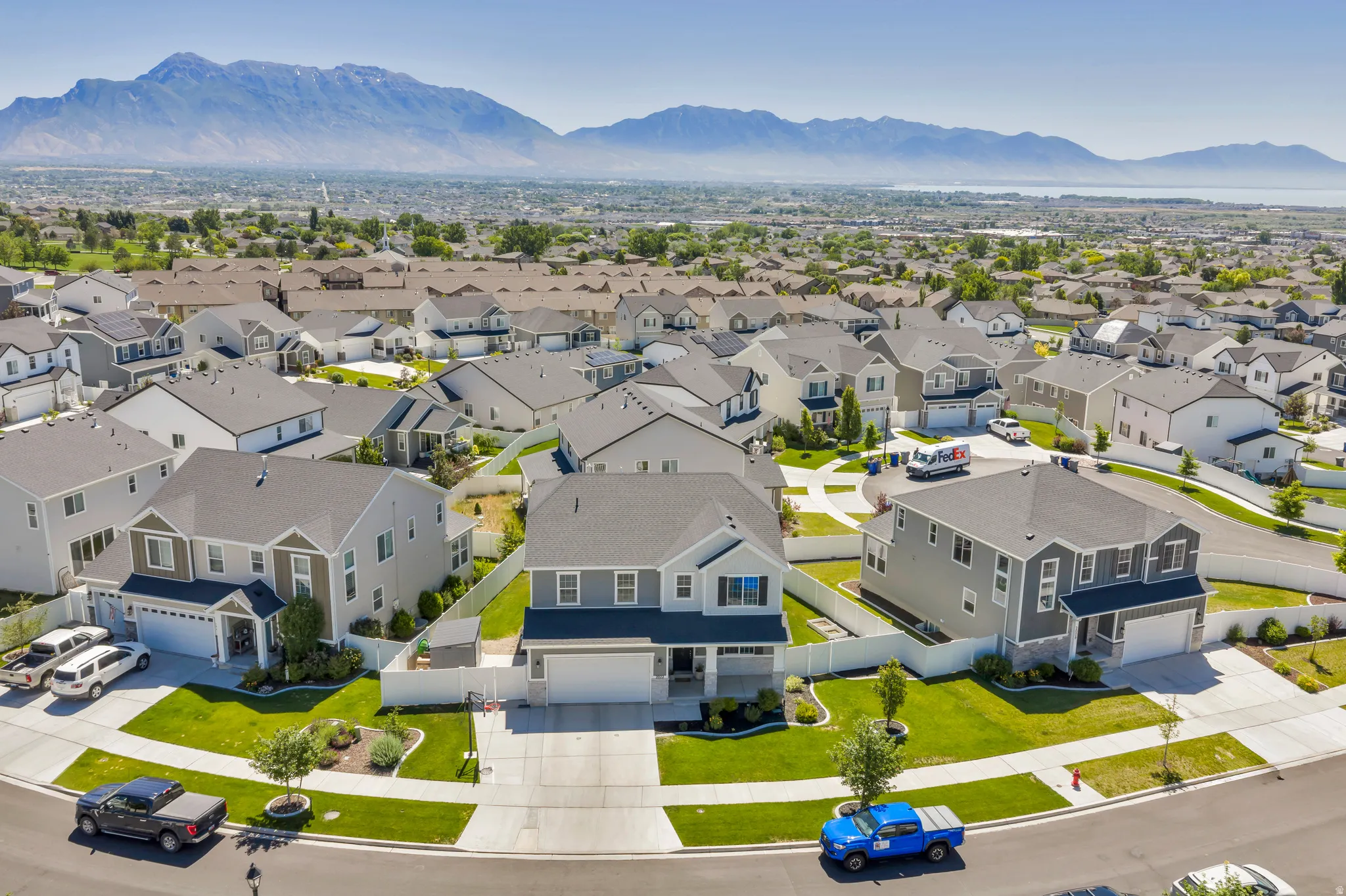 Aerial perspective showcasing a residential community with distant mountain and lake scenery