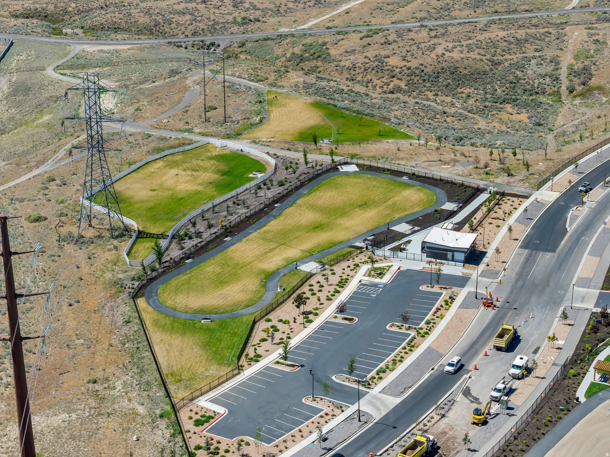 Expansive community green spaces featuring manicured lawns, walking paths, and a shaded pavilion