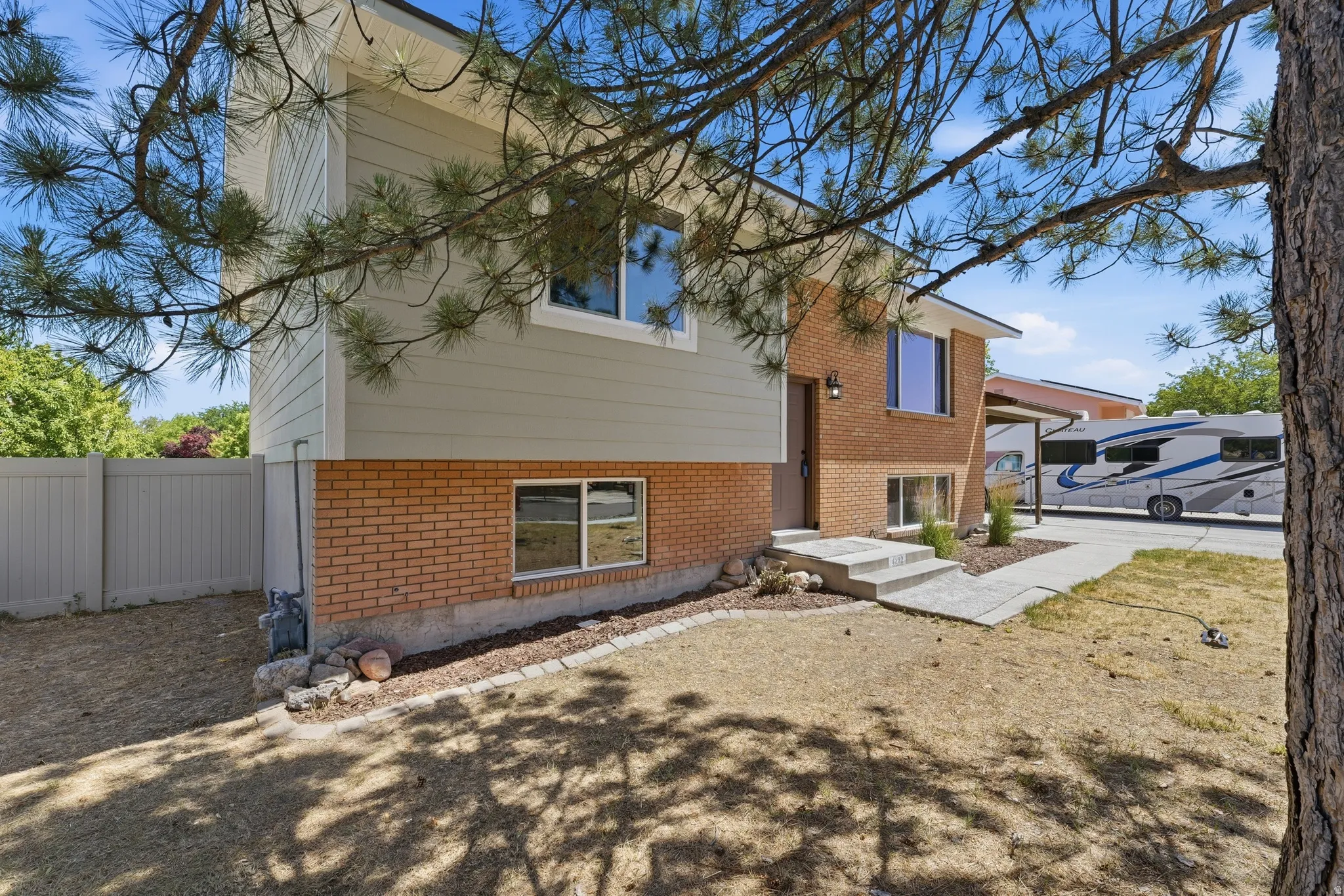 Split-level residence featuring brick and siding exterior