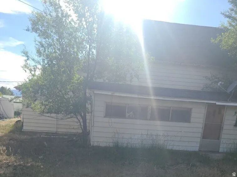 Exterior siding with multiple windows and a side entrance