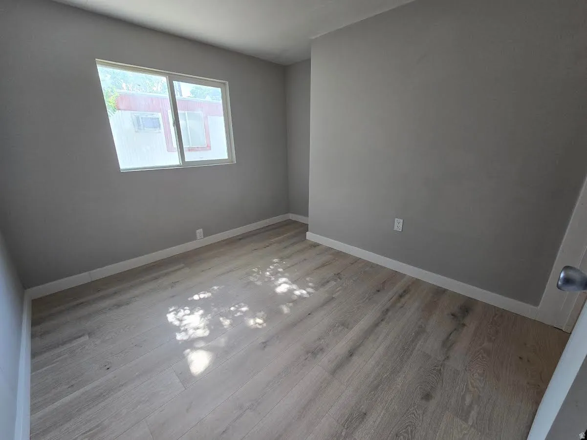 Bright room with light gray walls and wood-finish flooring