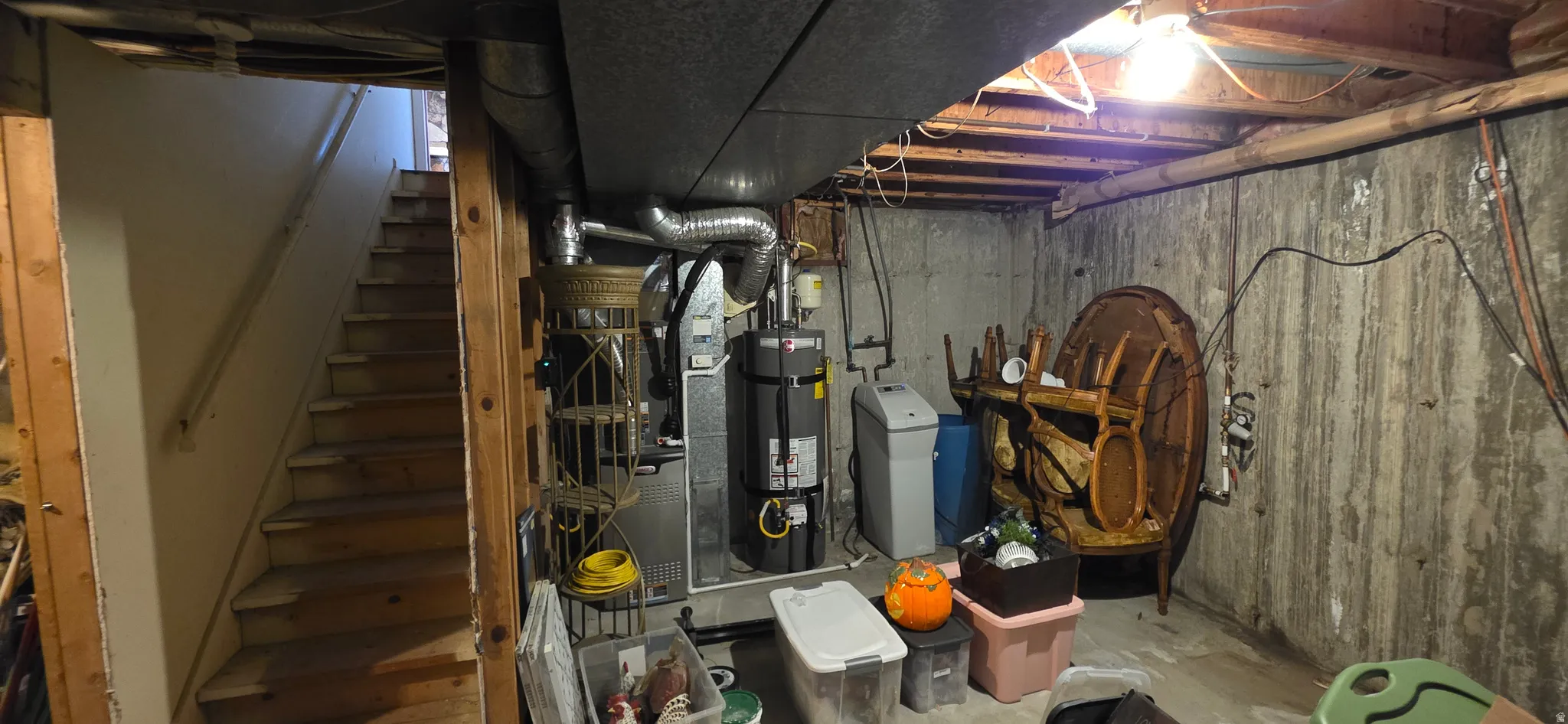 Basement area featuring a furnace, water heater, and water softener system