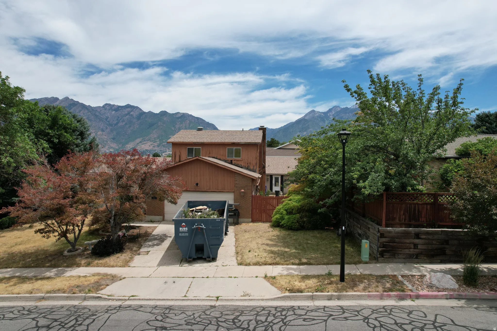 Residential property featuring a two-story design with an attached garage