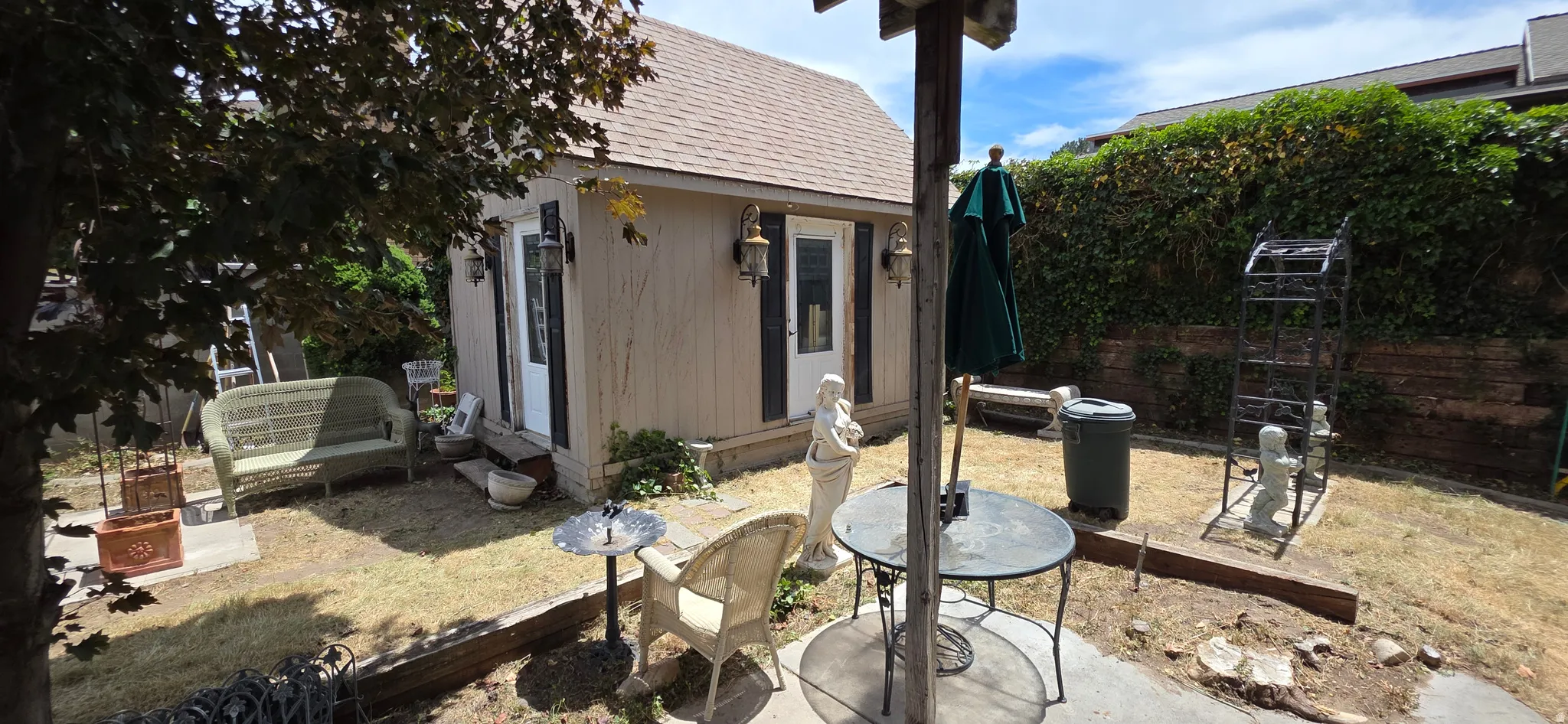Freestanding accessory building featuring a shingle roof and double entry doors