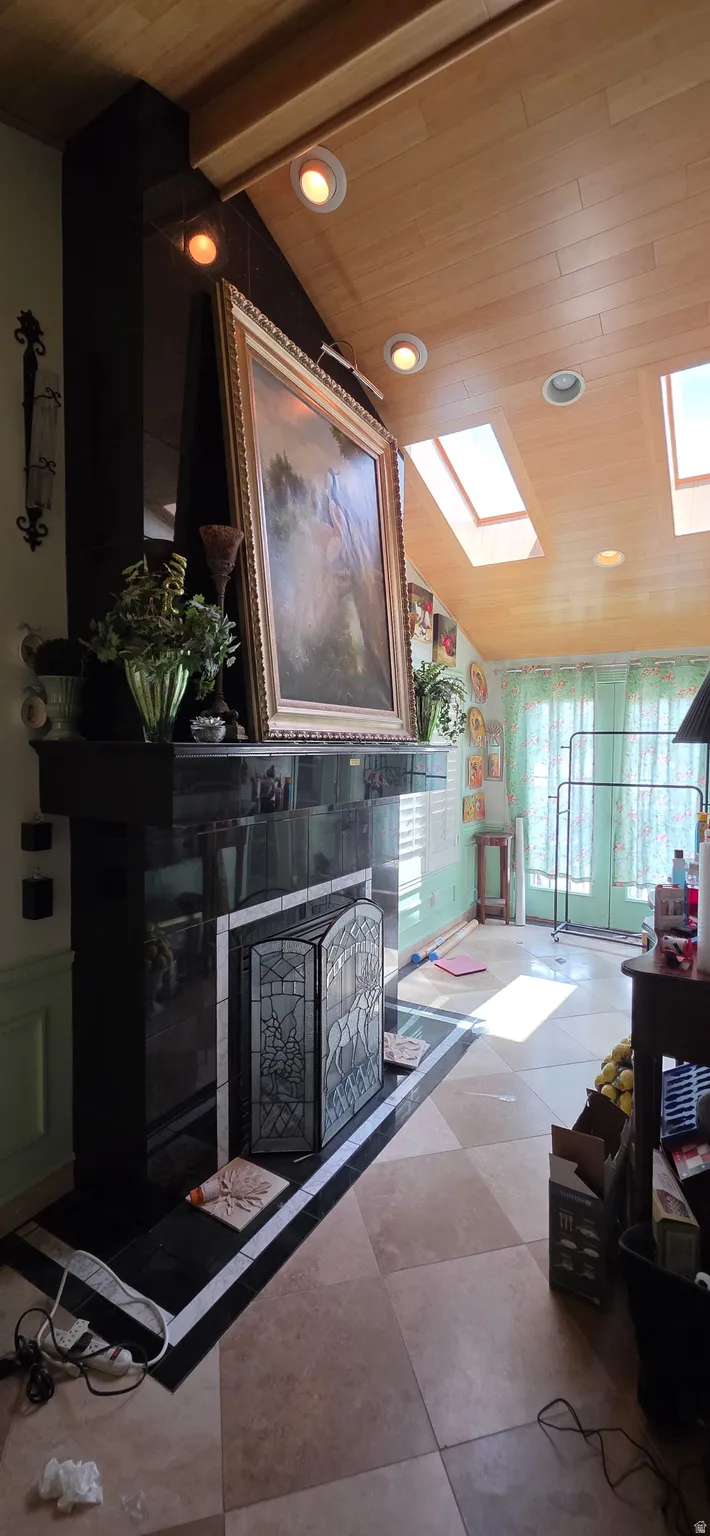 Fireplace featuring a black stone surround and hearth, complemented by a decorative screen