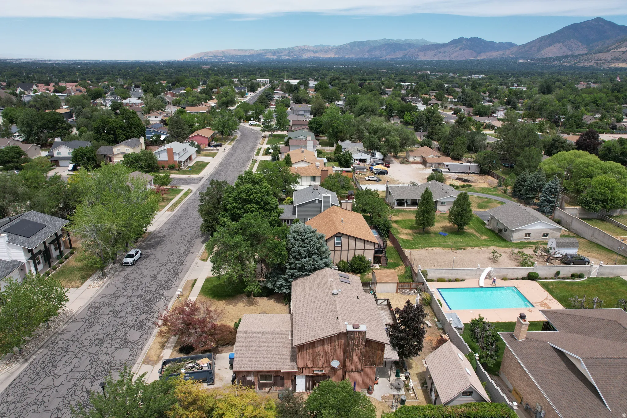 Aerial perspective showcasing residential properties and a mountain backdrop