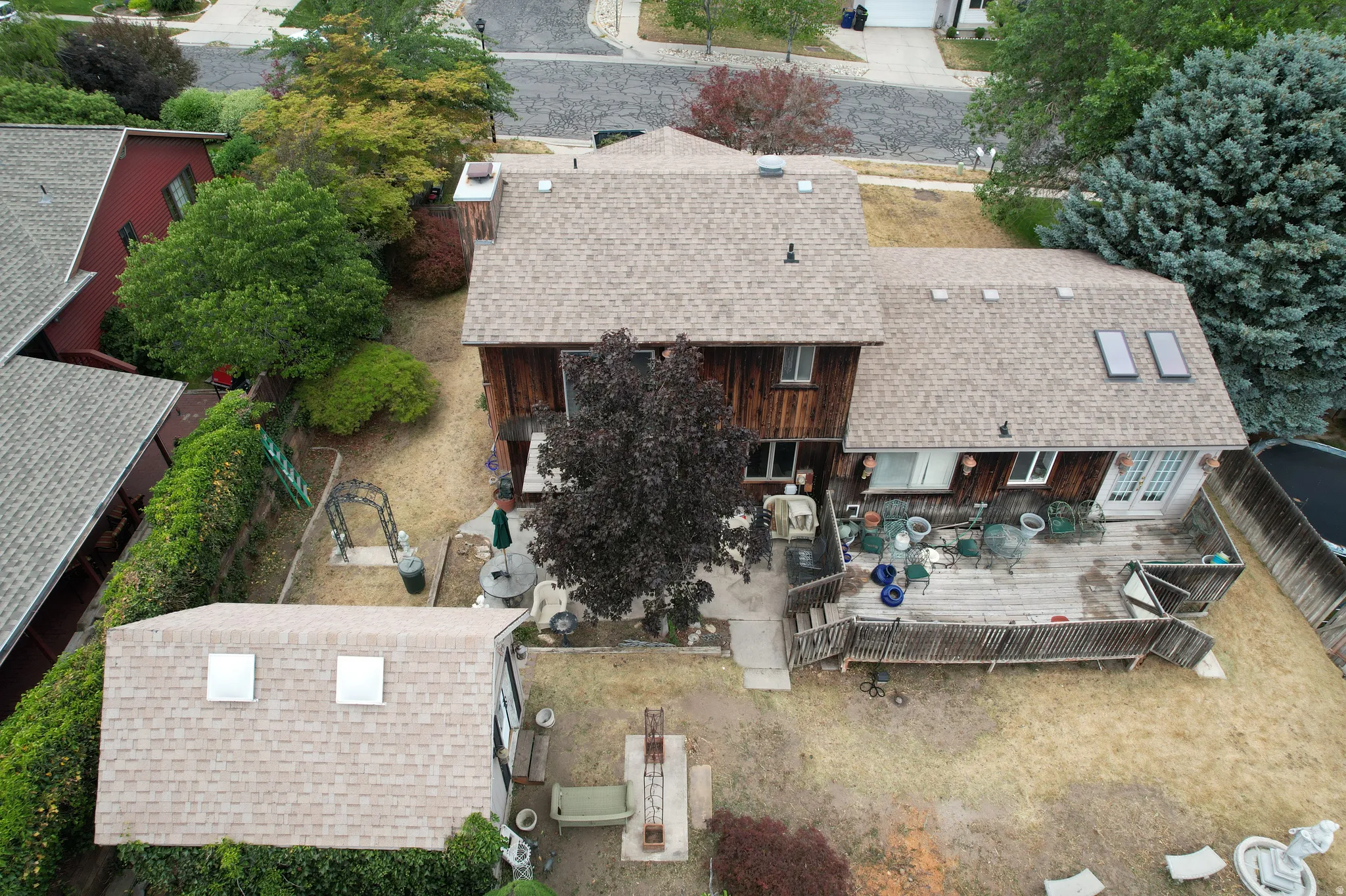Multi-level dwelling with a shingle roof and multiple skylights