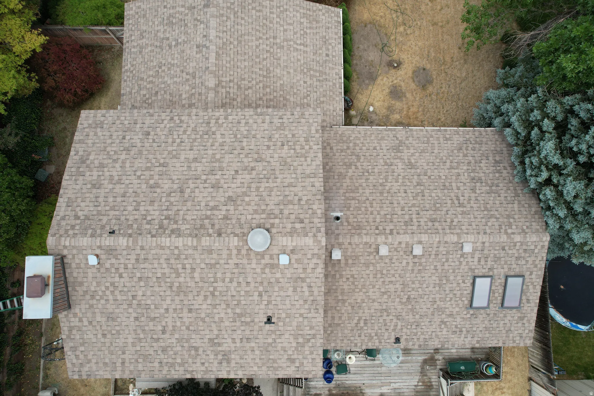 Asphalt shingle roof with multiple skylights and roof vents