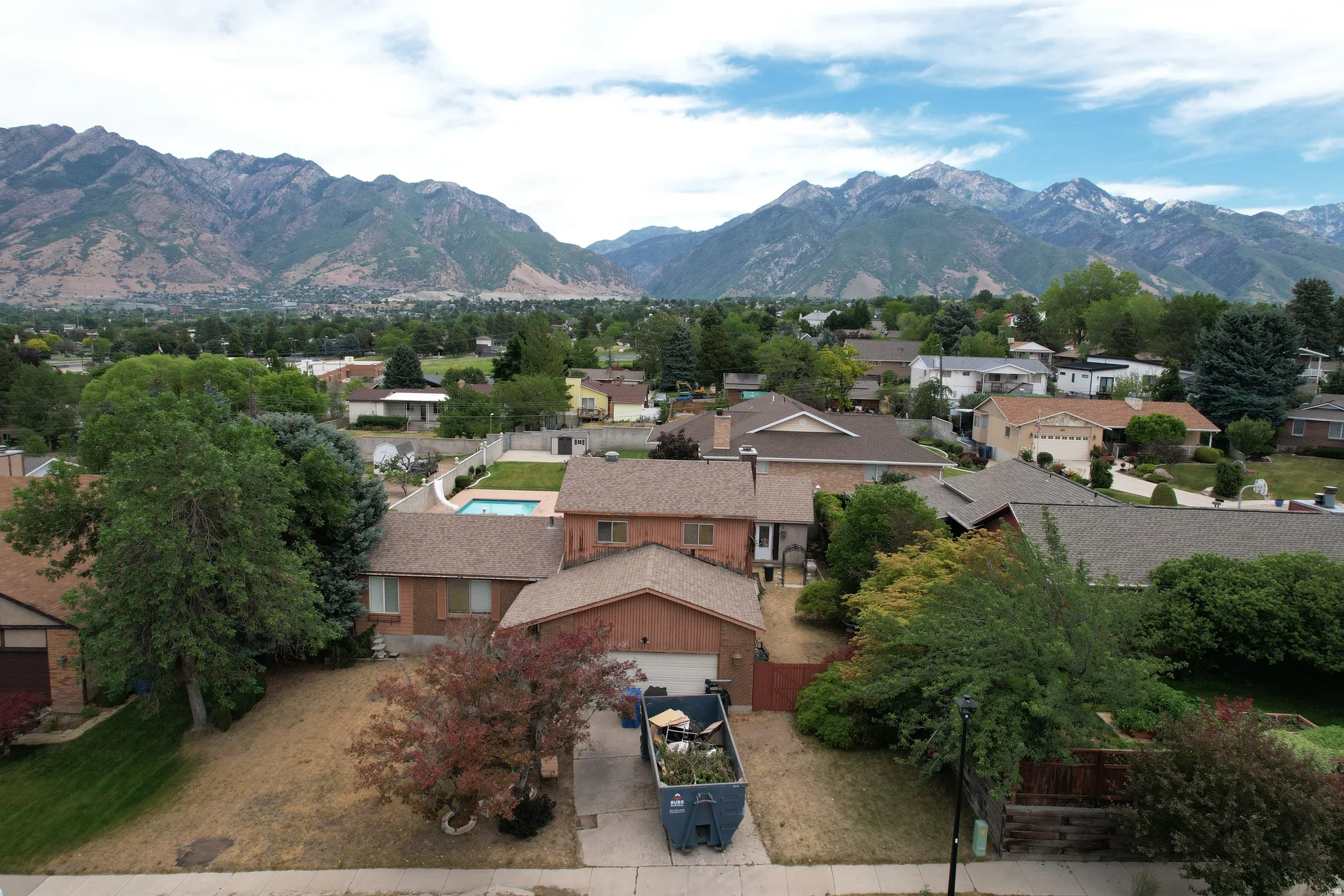 Mountain range backdrop framing a residential neighborhood with varied architectural styles