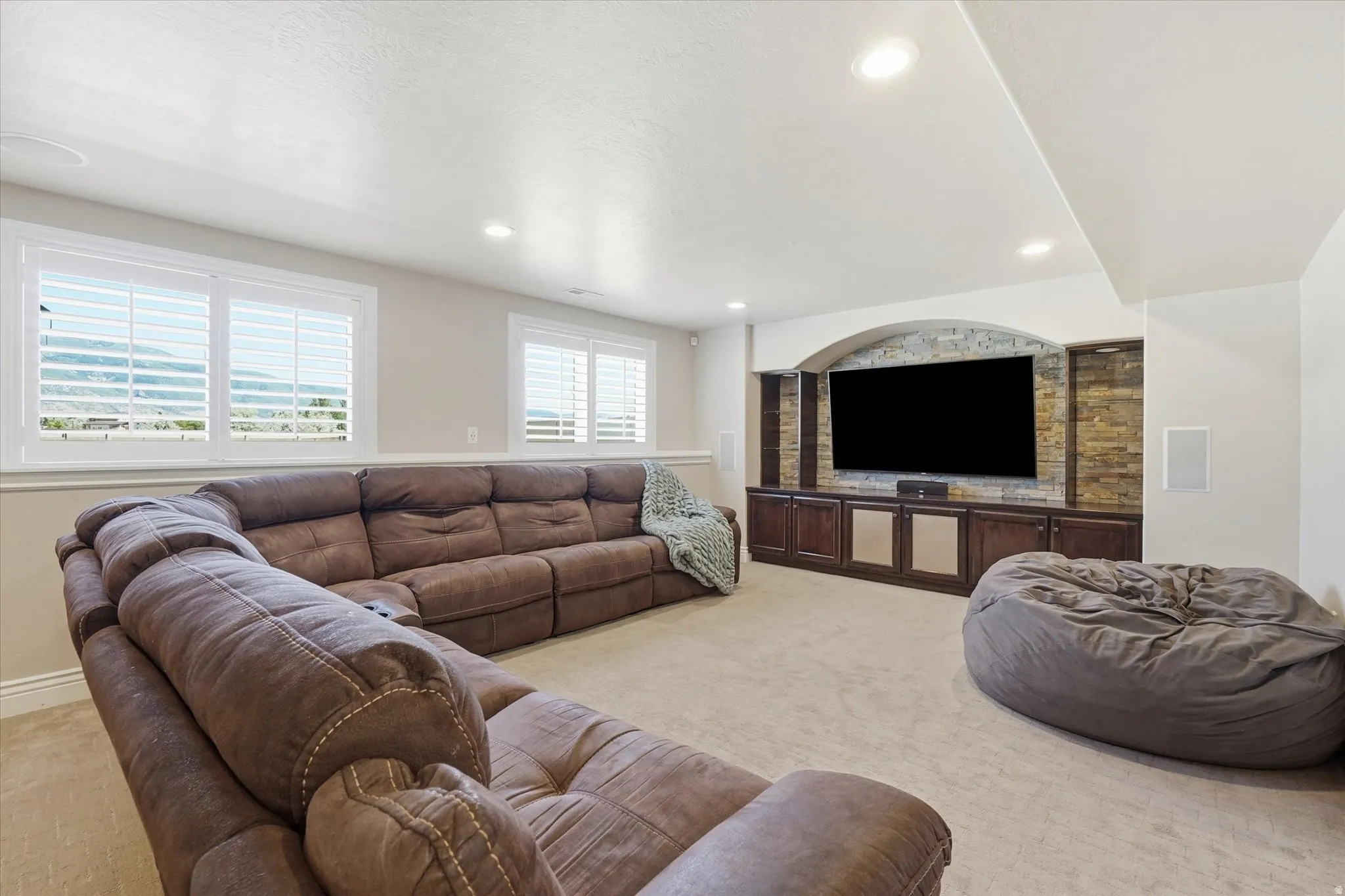Basement great room with plantation shutters.