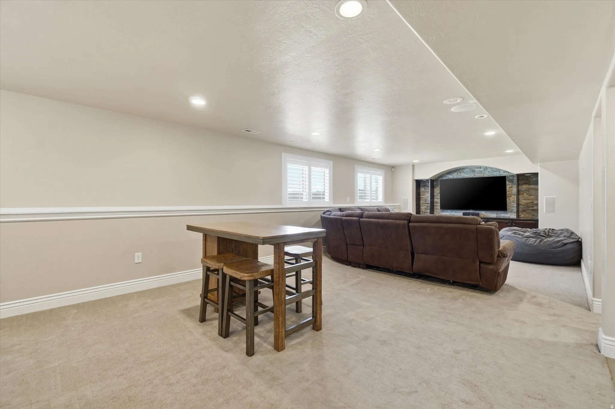 Basement great room with plantation shutters.