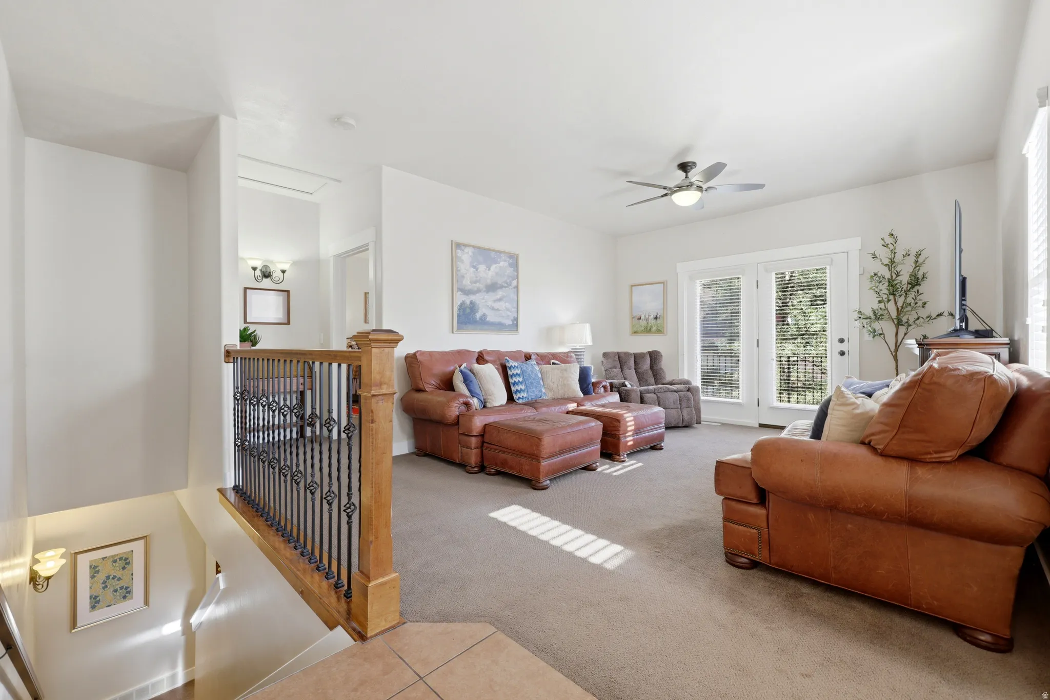Upper-level living area with neutral carpeting and light-colored walls