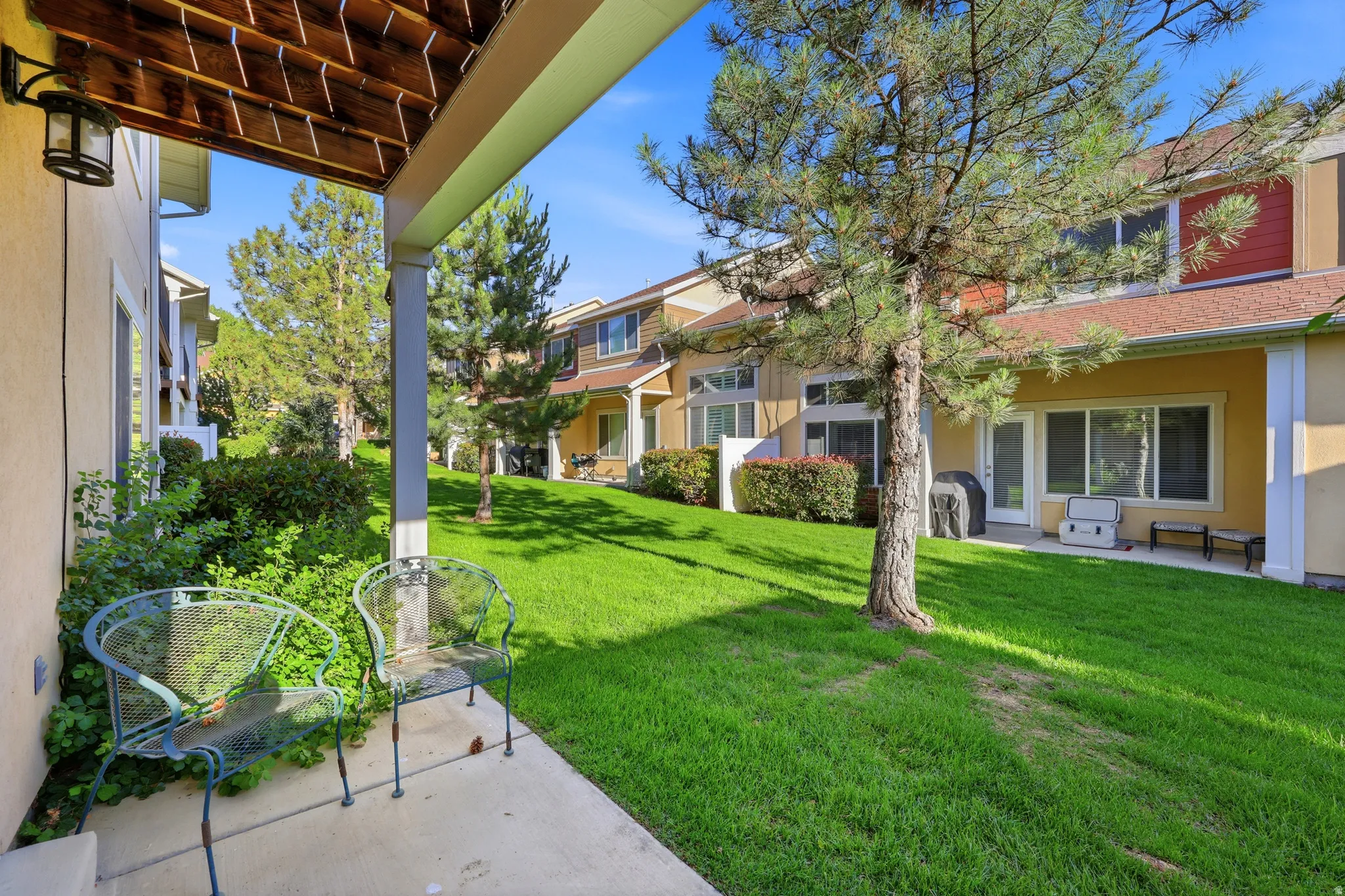 Covered patio space featuring a concrete surface and overhead wood-finish beams