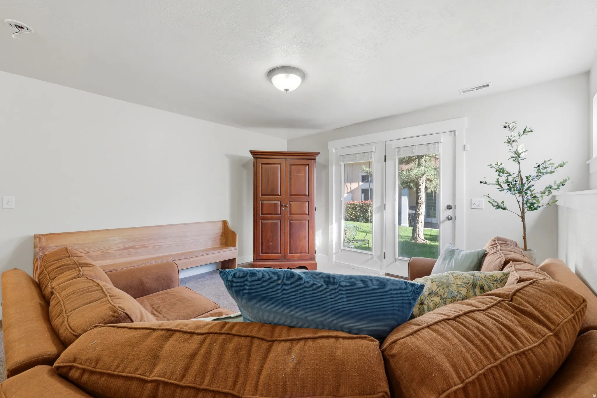 Living space featuring white walls, a flush-mount ceiling light, and light-colored flooring