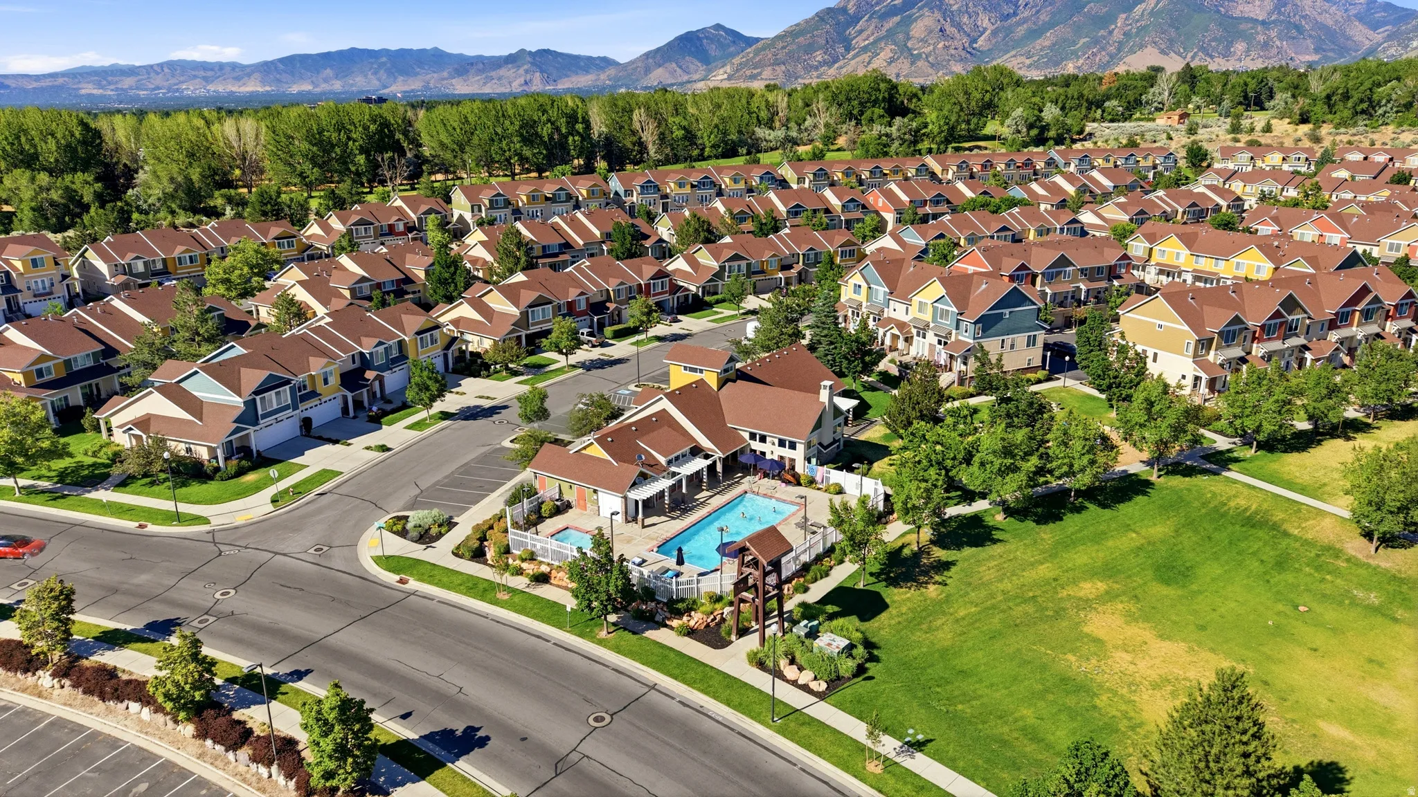 Residential community featuring a variety of multi-story homes with pitched roofs and multiple garages