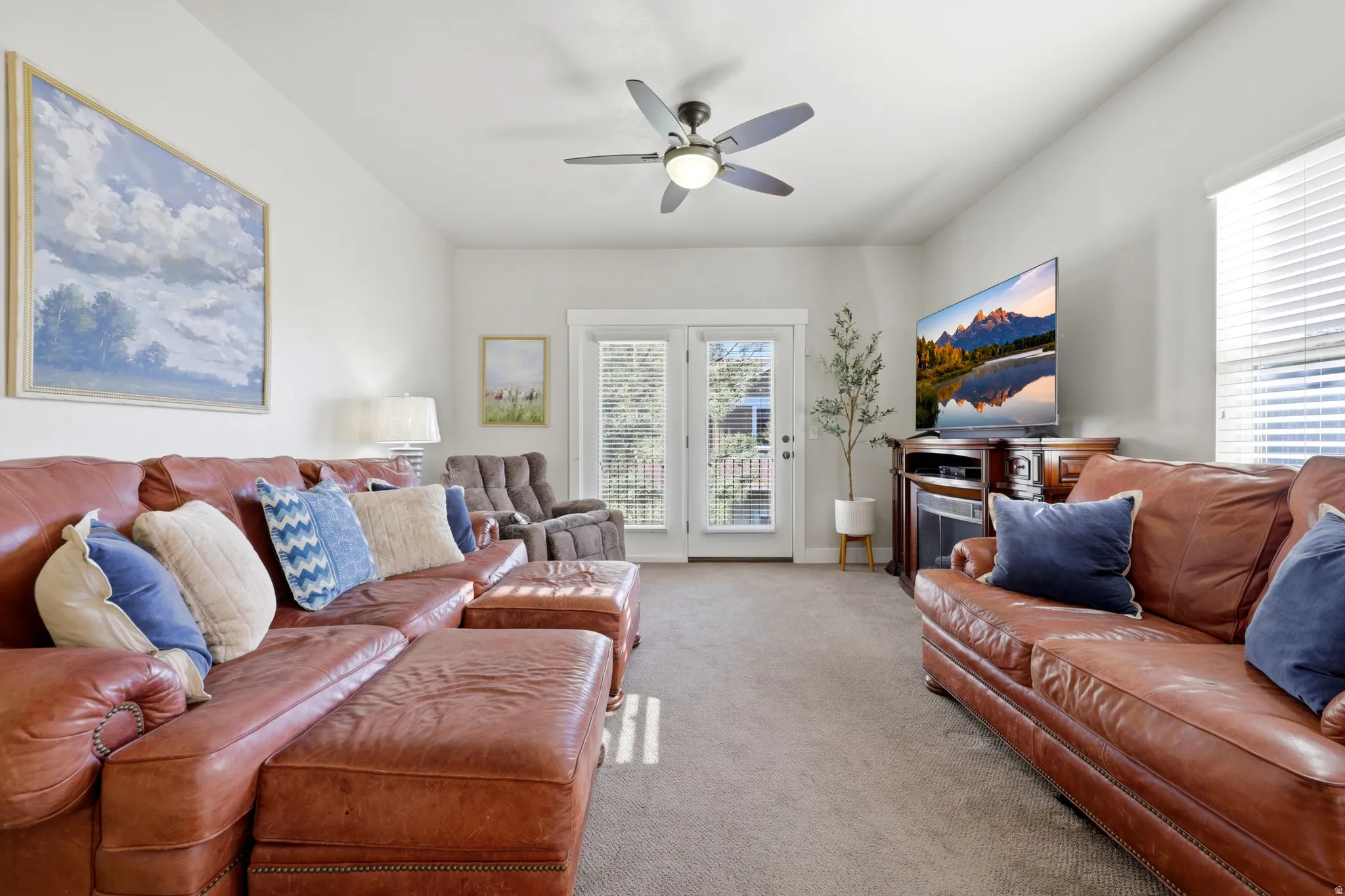 Living room featuring vaulted ceilings, recessed lighting, and neutral wall tones