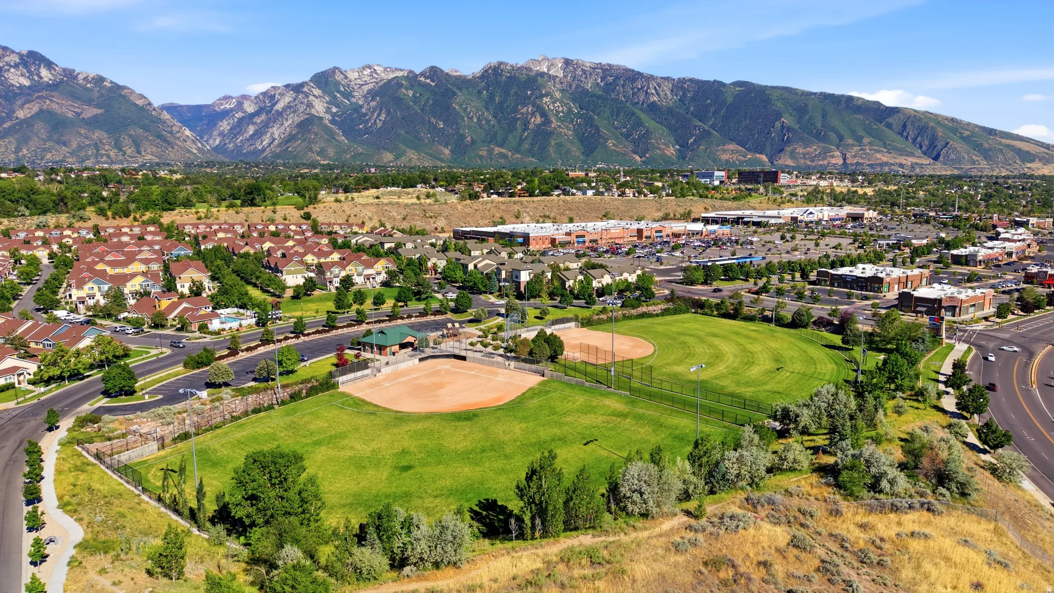 Expansive community offering a baseball field, mature landscaping, and mountain scenery