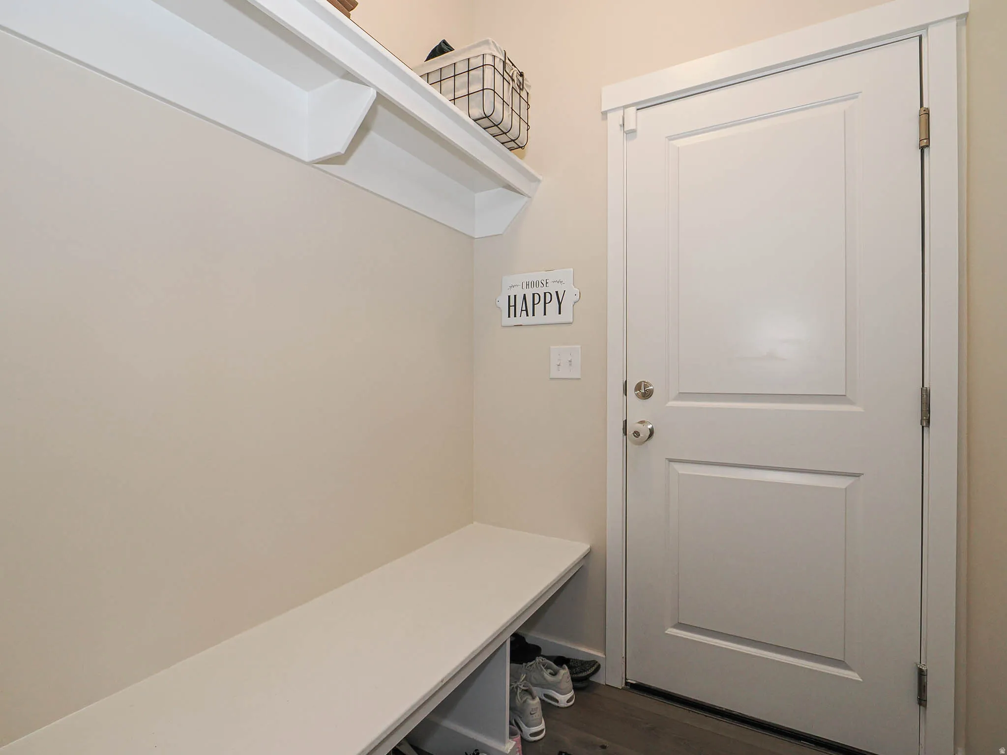 Built-in storage bench with an open shelf and upper shelving