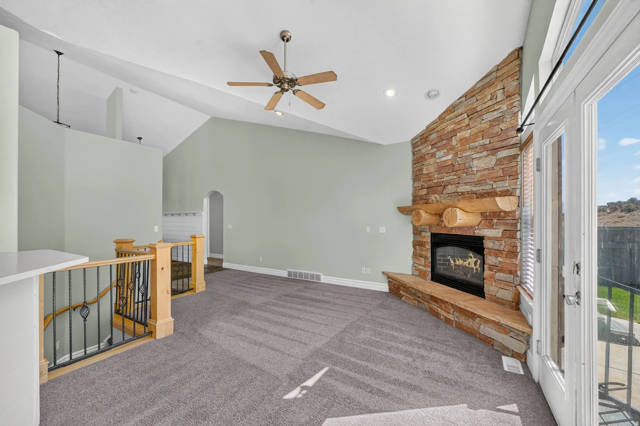 Living area with vaulted ceiling, ceiling fan, and recessed lighting