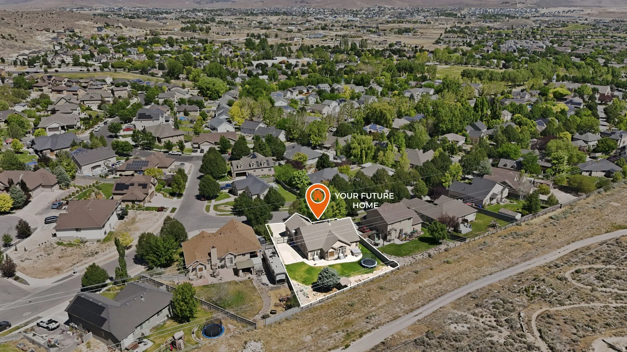 Aerial perspective showcasing a single-family residence within a residential development, surrounded by numerous mature trees
