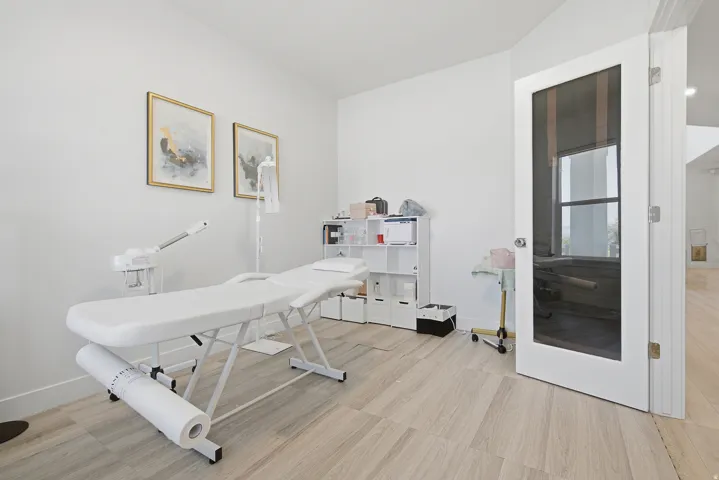 Bright room featuring light wood-finish flooring and white baseboards