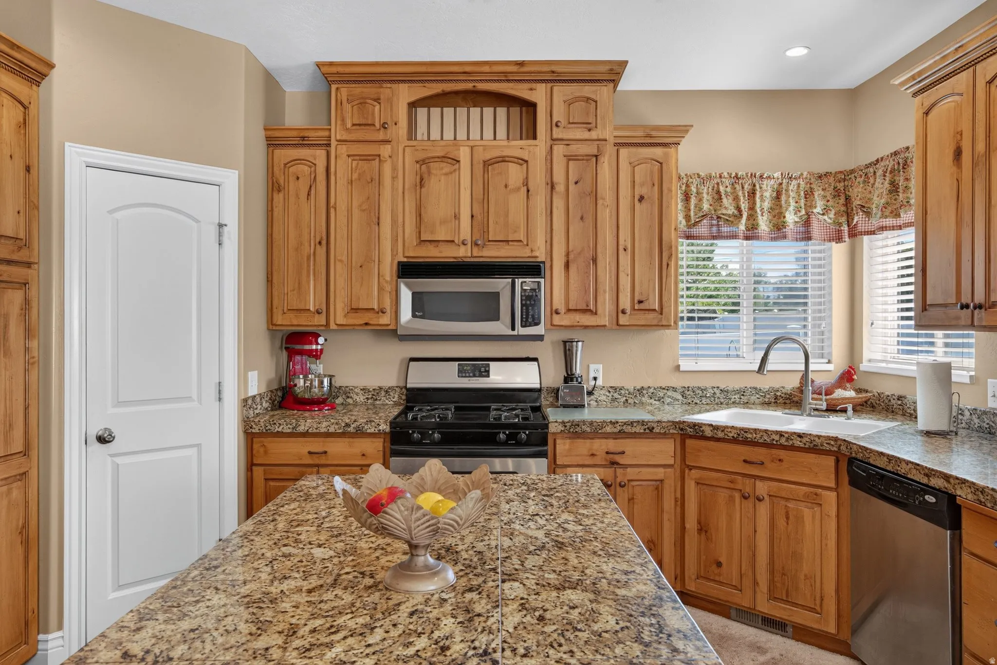 Kitchen featuring wood cabinetry with crown molding details