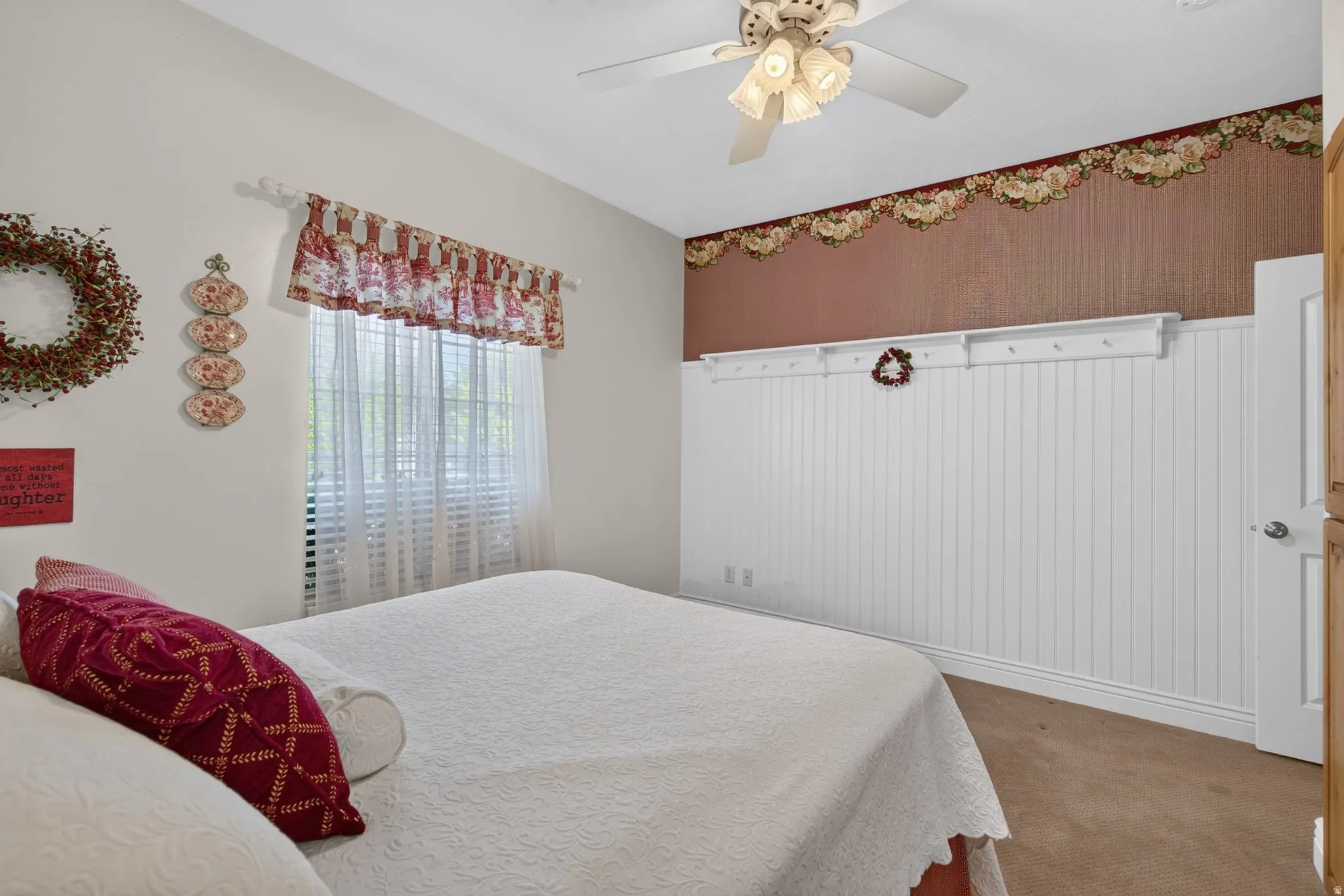 Bedroom featuring a window with blinds, a ceiling fan with integrated lighting, and carpet flooring