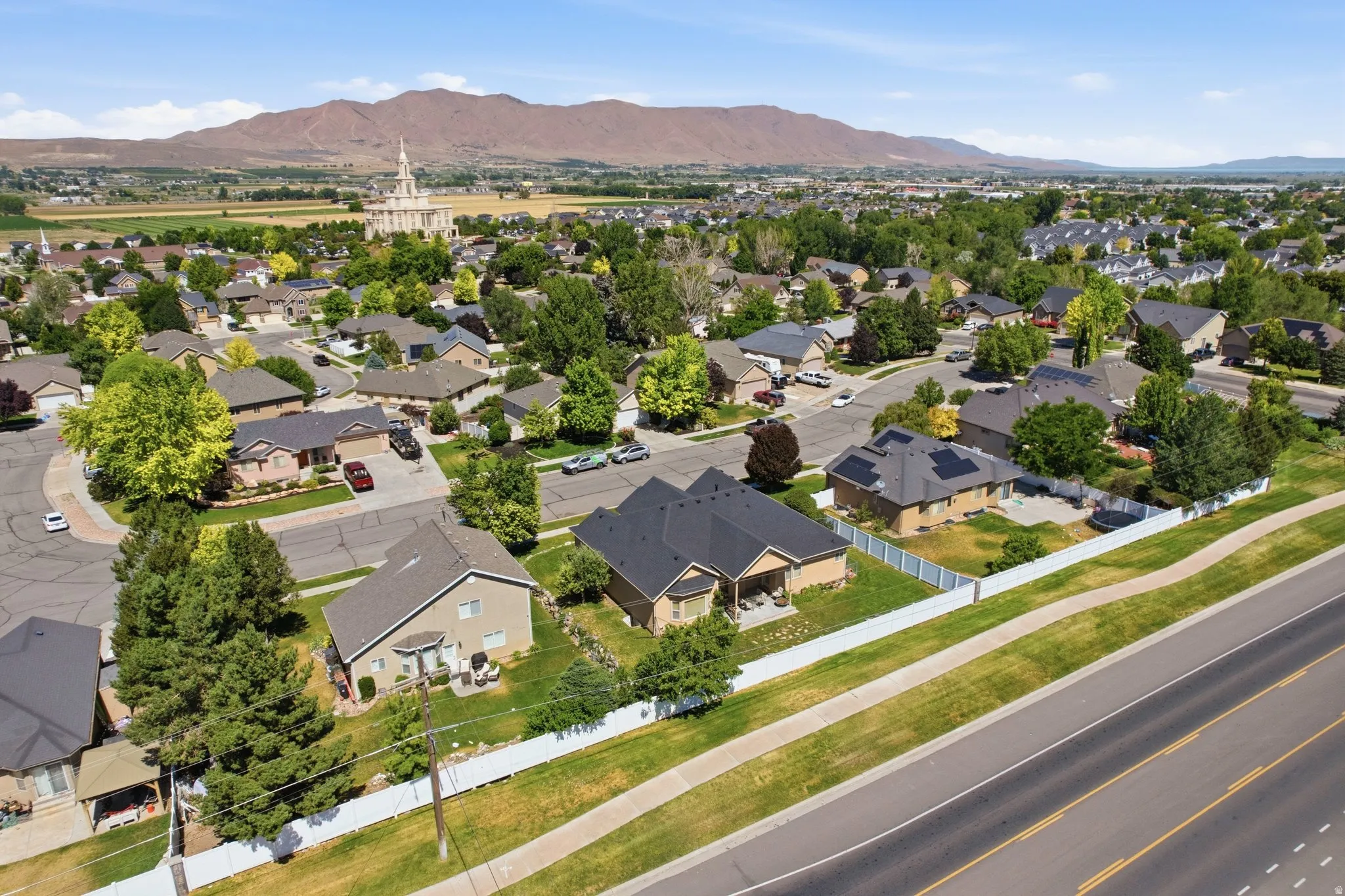 Aerial perspective showcasing a residential neighborhood with varied home styles and mature trees