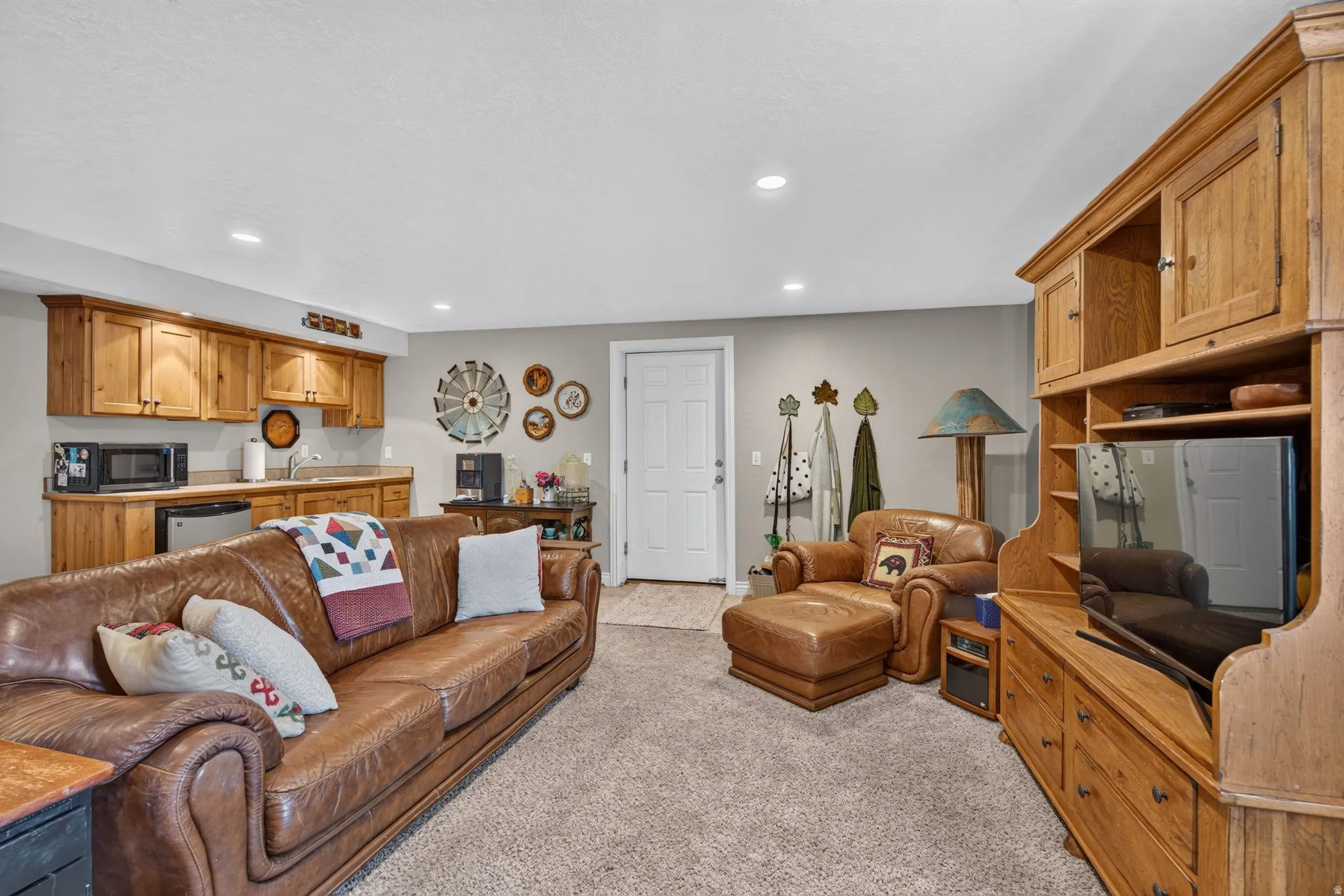 Carpeted recreation room featuring recessed lighting and light gray wall paint