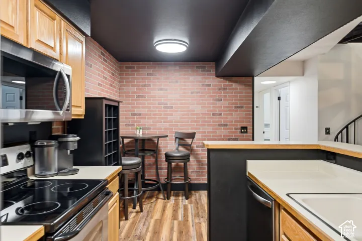 Kitchenette featuring stainless steel appliances including a built-in microwave and electric range