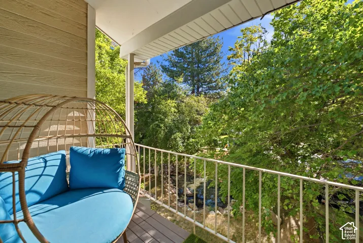 Private balcony featuring composite decking and a white metal railing