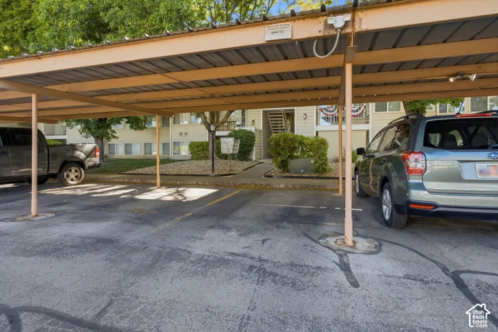 Covered parking structure featuring metal roofing and support columns
