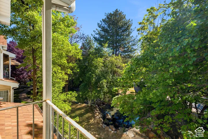 Balcony featuring a metal railing and a shingle roof detail