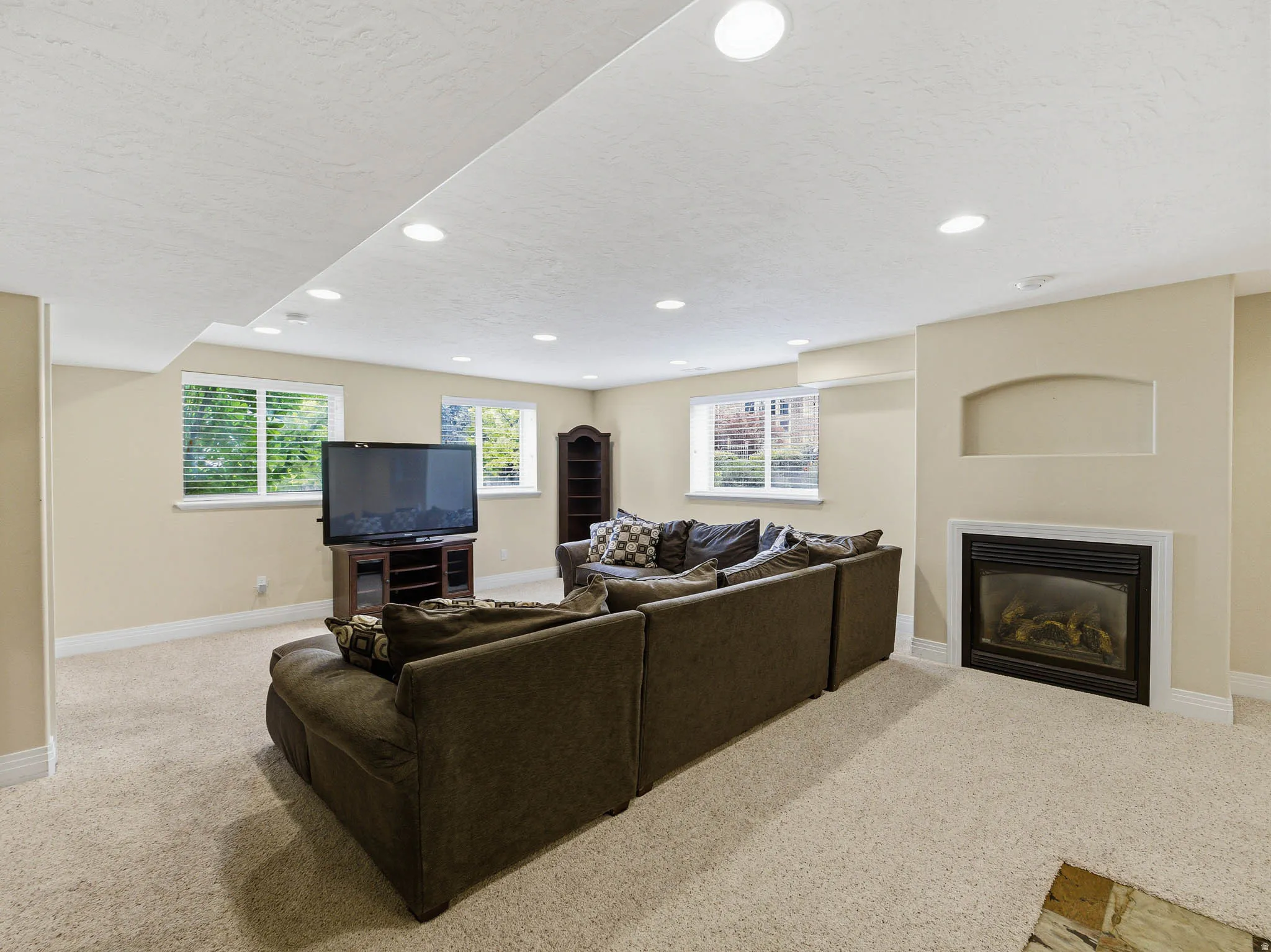 Spacious room featuring neutral carpeting and recessed lighting