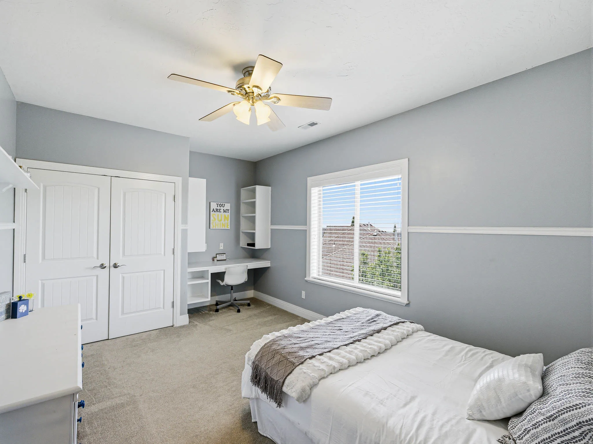 Room featuring light gray walls, white trim, and light-colored carpet