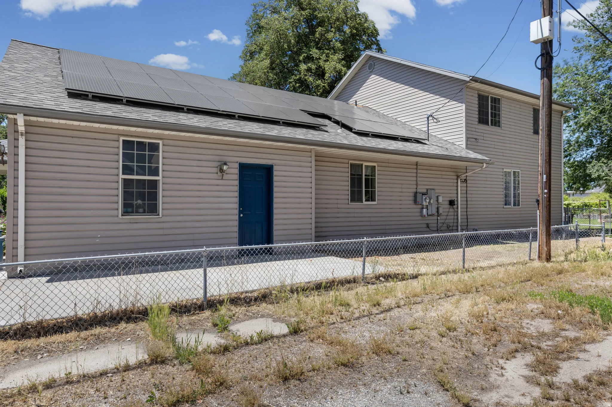 Property exterior featuring horizontal siding and a dark-paneled roof