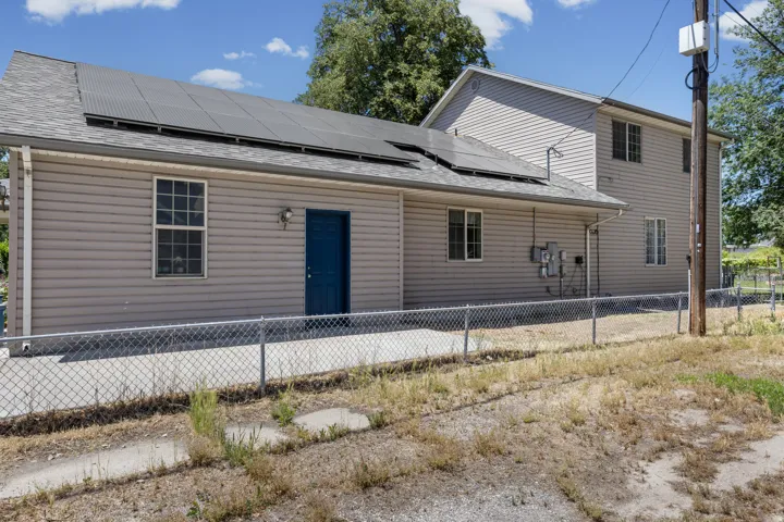 Property exterior featuring horizontal siding and a dark-paneled roof