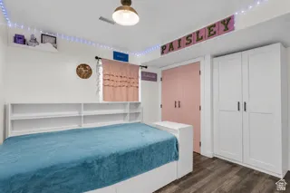 Basement bedroom with double door closets with virtual bedding