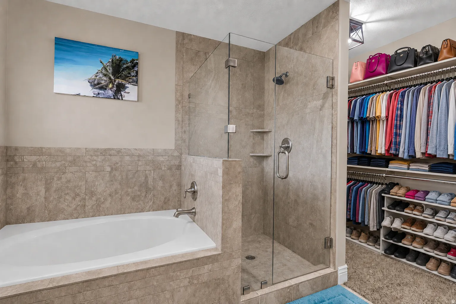 Bathroom featuring a built-in tub with brushed nickel fixtures, a glass-enclosed shower with tile surround, and an adjacent walk-in closet with extensive custom shelving and hanging rods