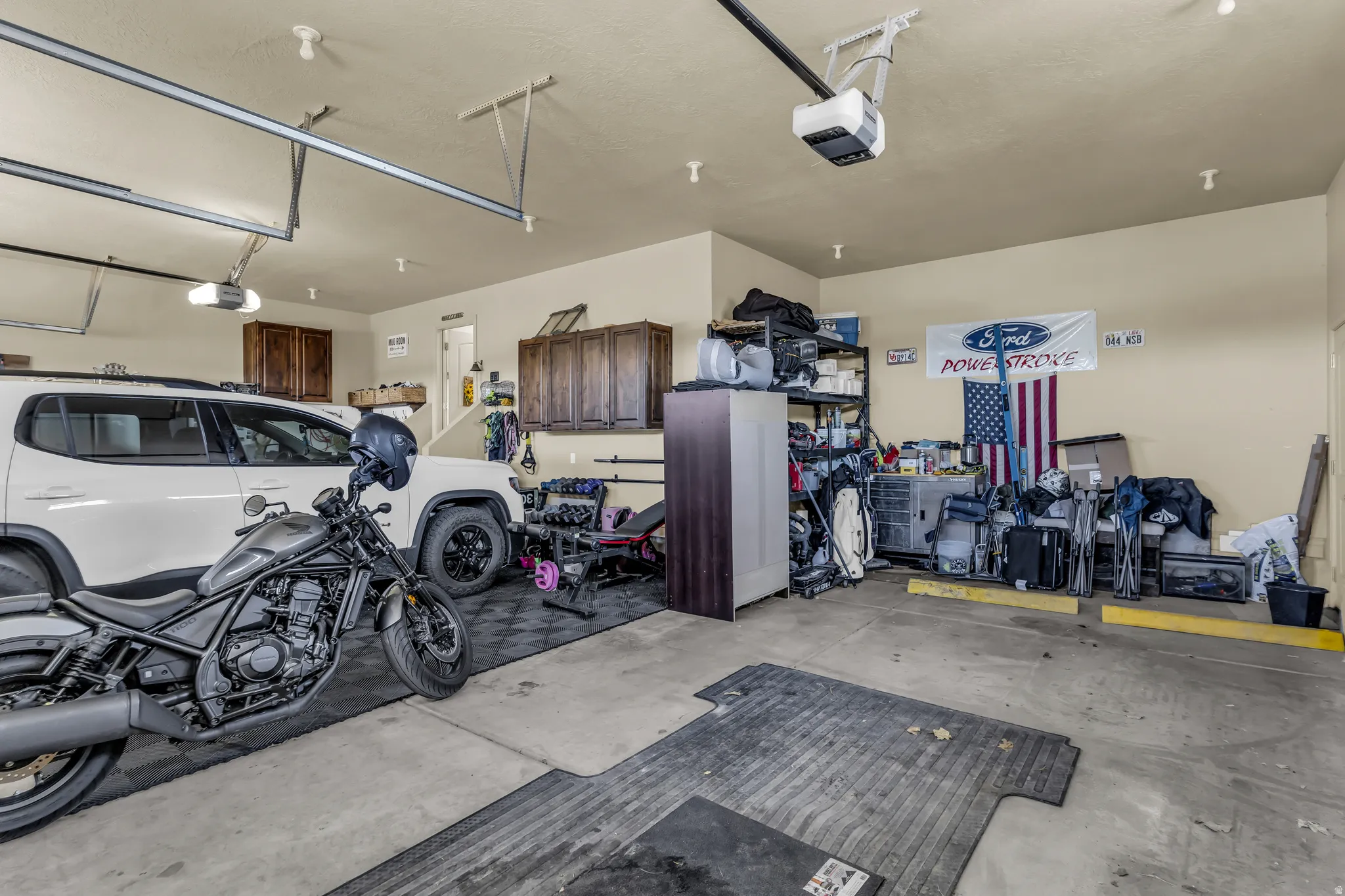 Spacious garage featuring concrete flooring and light-toned walls