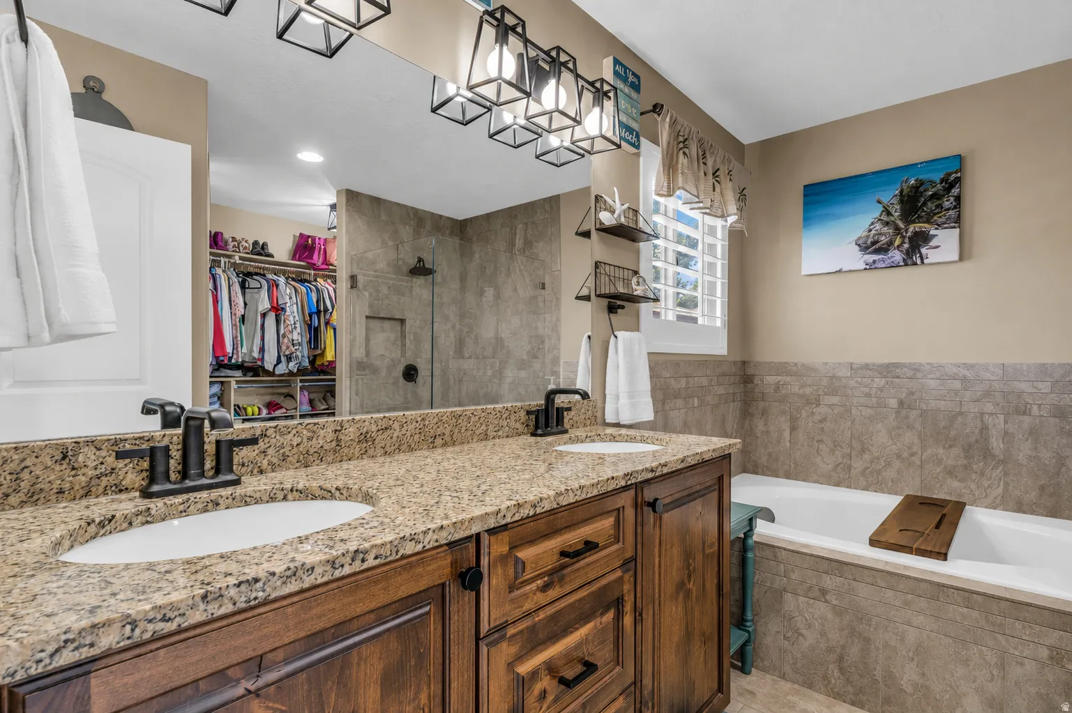 Double vanity with granite countertops and dark wood cabinetry