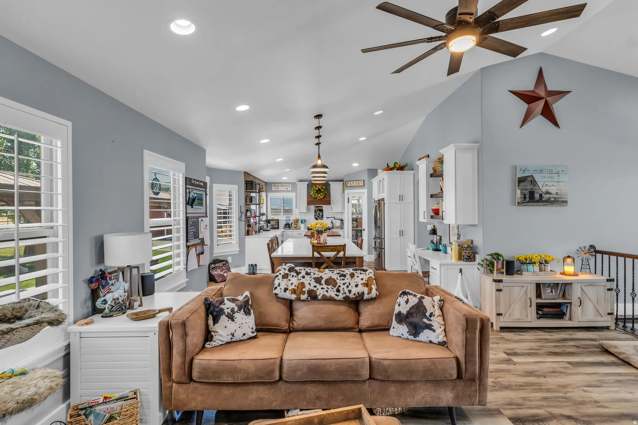 Vaulted ceiling featuring a large wood-finish ceiling fan and recessed lighting