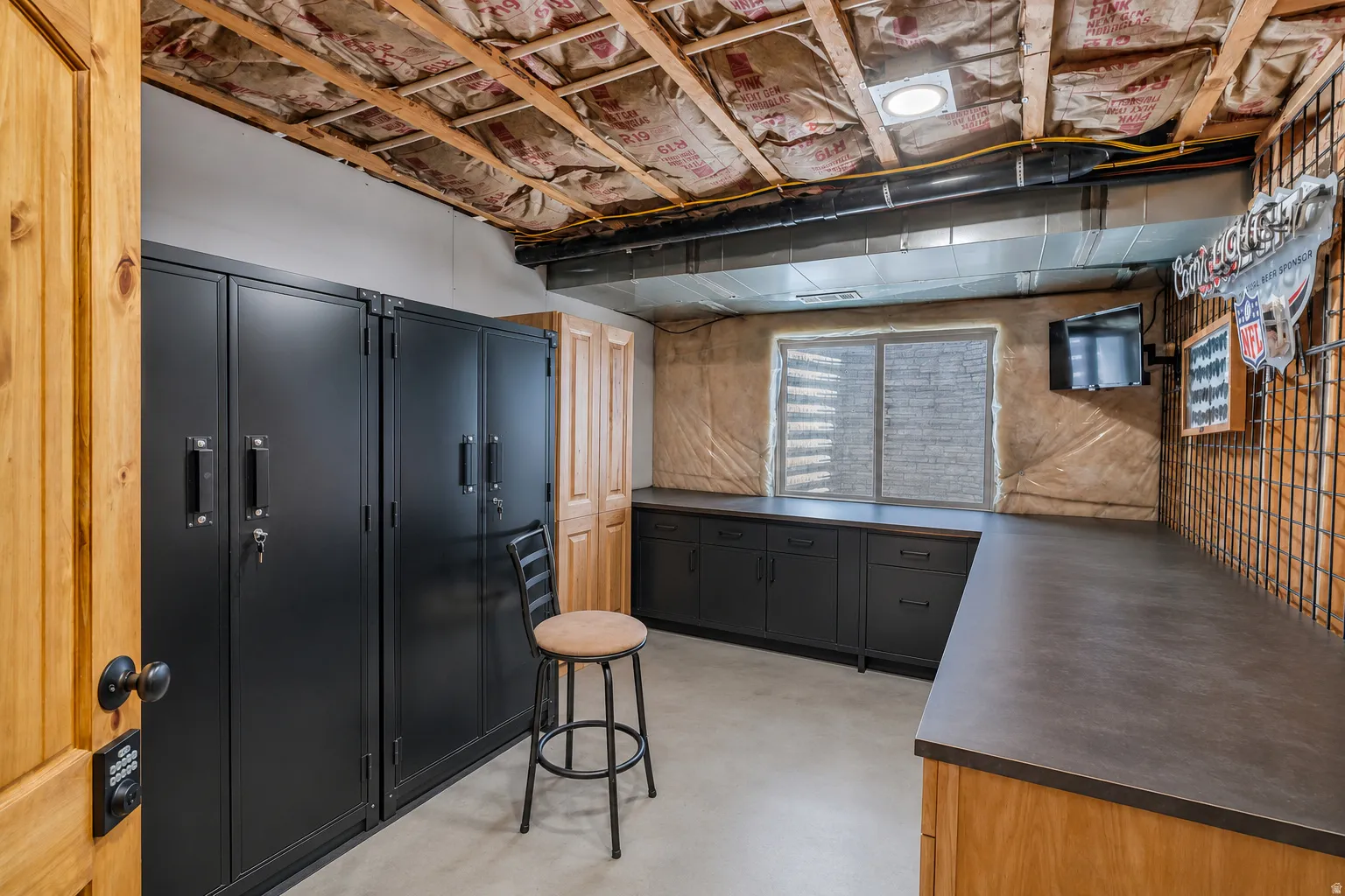 Utility room featuring extensive dark-finish cabinetry with integrated countertops