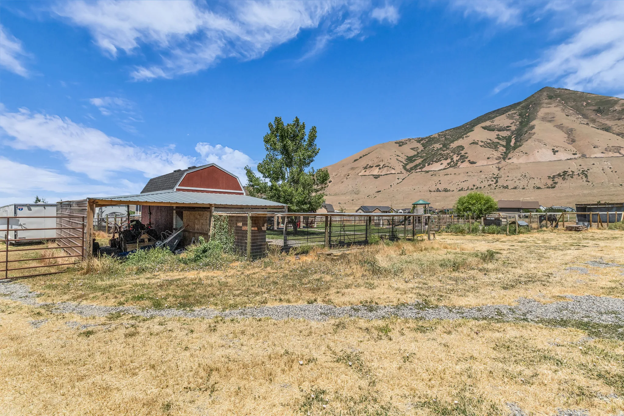 Red barn structure with a gray metal roof