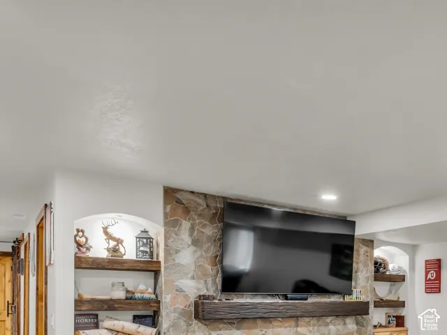 Feature wall with stacked stone surround and integrated linear fireplace