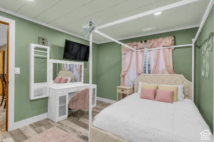Virtually cleared of items and decor. Bedroom 4 Room featuring wood-finish flooring, recessed lighting, and a window with natural light