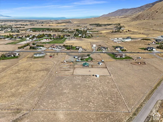 Expansive land parcel with surrounding agricultural fields and a mountainous backdrop
