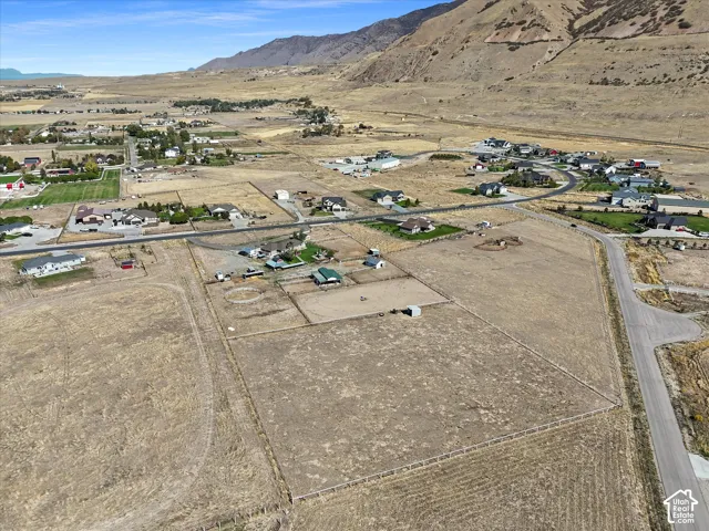 Additional contentThe image shows an aerial view of agricultural land and scattered residential properties in a valley setting