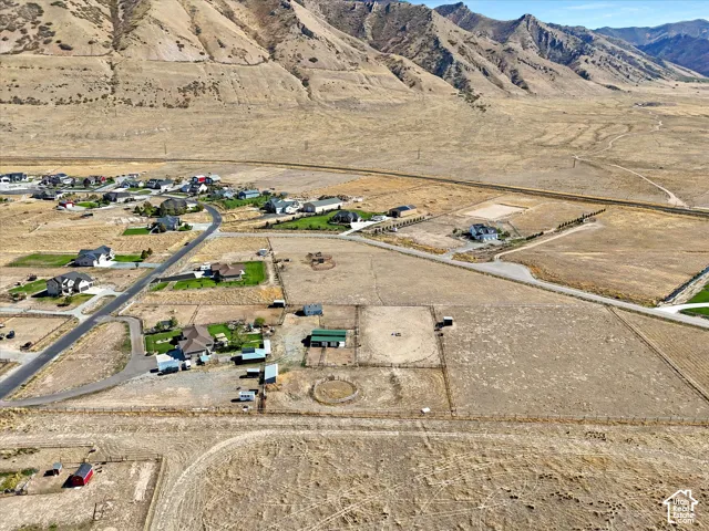 Expansive property featuring mountainous terrain, residential developments, and multiple outbuildings